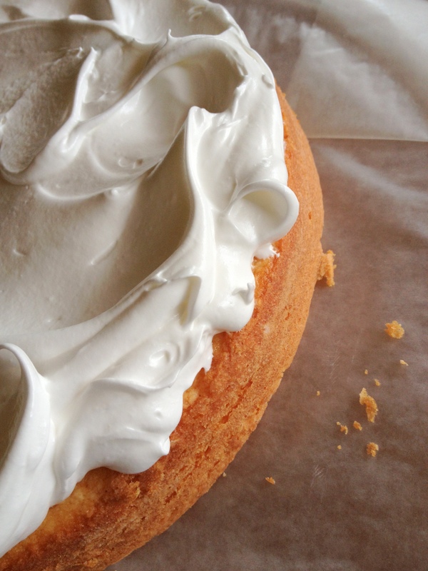 The cake layers are baked, and the first swirls of White Mountain Frosting are applied.