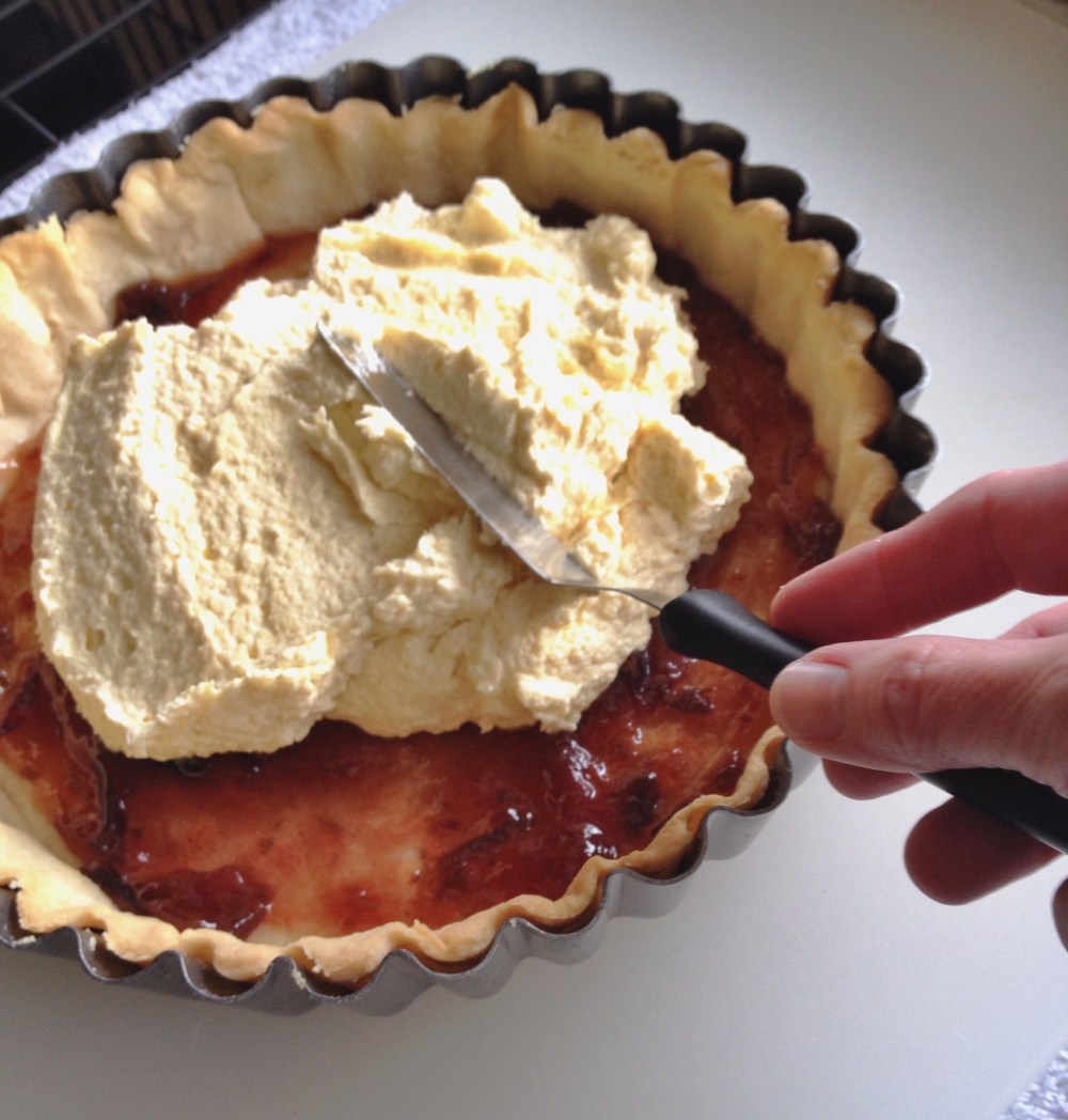 Topping the plum jam layer with frangipane
